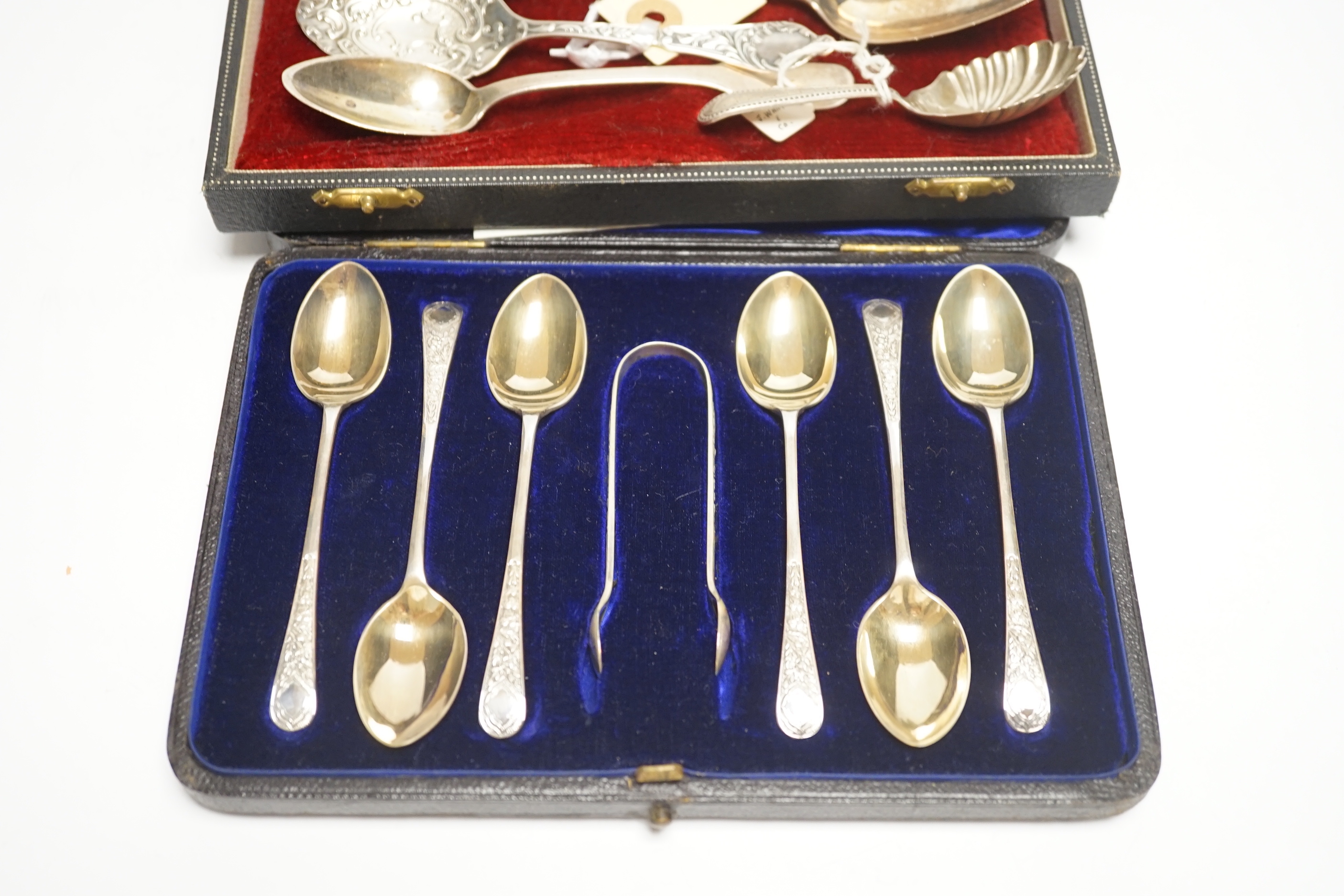 A cased set of six silver teaspoons and tongs and four other assorted silver or white metal spoons, including a caddy spoon.